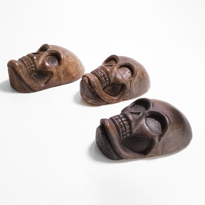 Lot 274 - Three carved wood human skulls