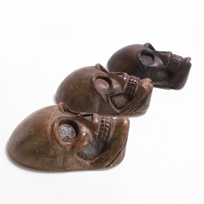 Lot 274 - Three carved wood human skulls