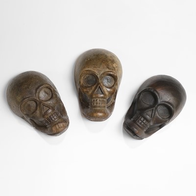 Lot 274 - Three carved wood human skulls