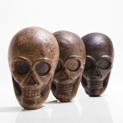 Lot 274 - Three carved wood human skulls