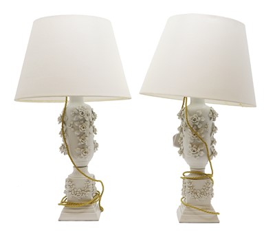 Lot 559 - A pair of French white porcelain and floral encrusted table lamps