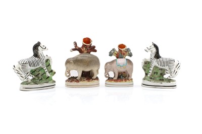 Lot 103 - A pair of Staffordshire pottery zebras