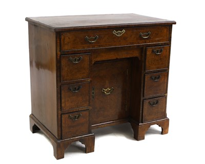 Lot 692 - A Georgian walnut kneehole desk