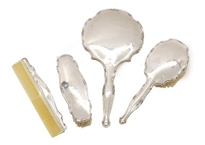 Lot 32 - A four piece silver back dressing table set