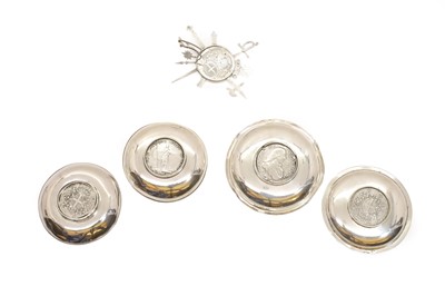 Lot 36 - A group of four silver mounted coin dishes