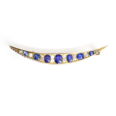 Lot 25 - An Edwardian sapphire and diamond crescent brooch