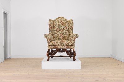 Lot 543A - A carved walnut wing armchair in the 17th-century taste