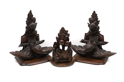 Lot 321 - A pair of carved walnut 'Eagle' wall brackets