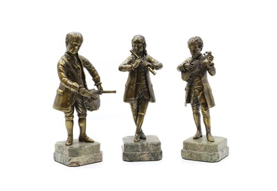 Lot 196 - A set of three bronze musicians