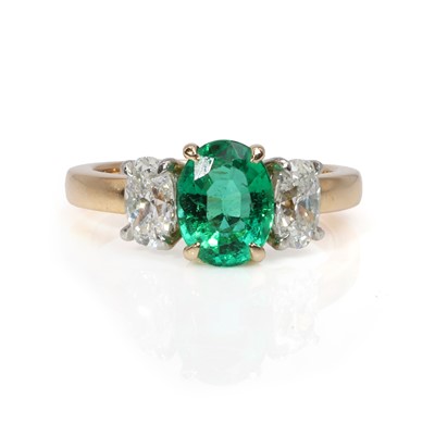 Lot 237 - An 18ct gold emerald and diamond three stone ring