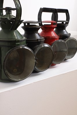 Lot 470 - A set of four painted railway oil lamps