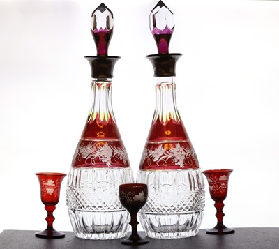 Lot 288 - A pair of cranberry and clear cut glass decanters and stoppers