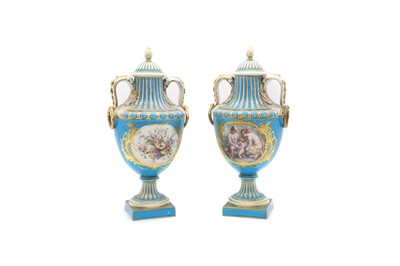 Lot 123 - A pair of Sevres style porcelain urns and covers