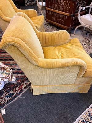 Lot 426 - A pair of upholstered armchairs in the style of Howard & Sons