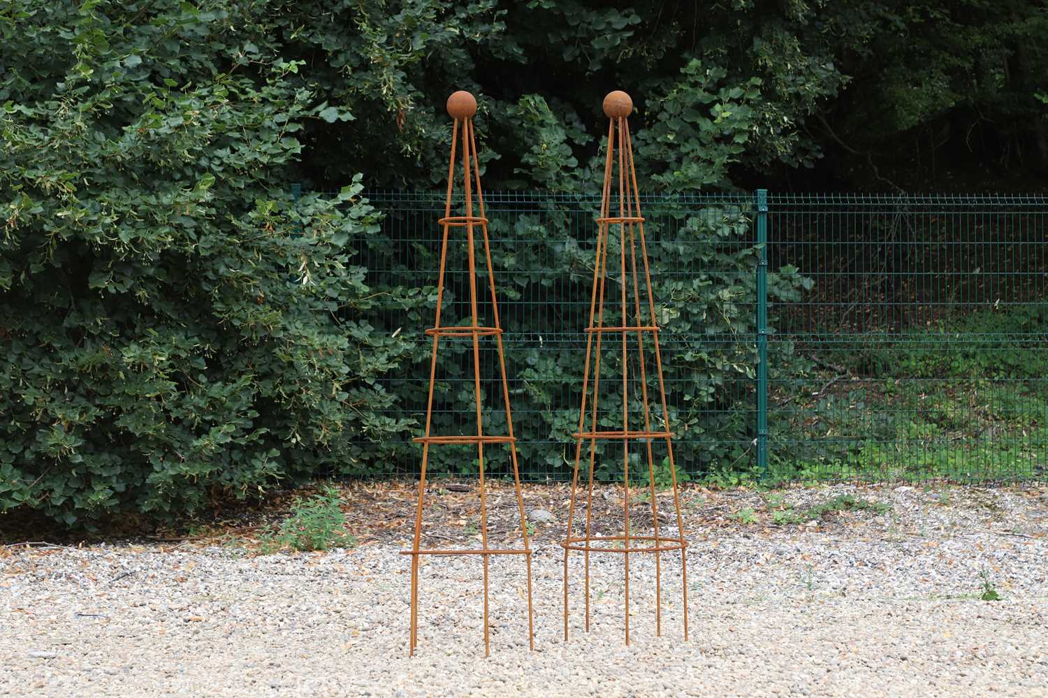 Lot 758 - A pair of metal obelisk planters
