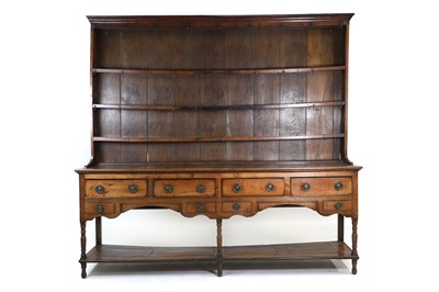 Lot 454 - A large George III oak pot board dresser