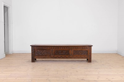 Lot 636 - A carved chestnut coffer