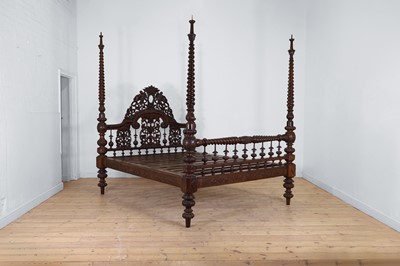 Lot 493 - A carved hardwood four-poster bed