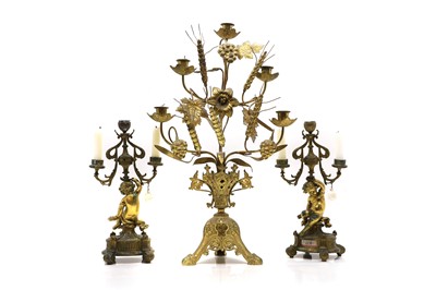 Lot 334 - A pair of gilt bronze three branch figural candlesticks