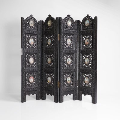 Lot 147 - An Anglo-Indian carved hardwood table screen