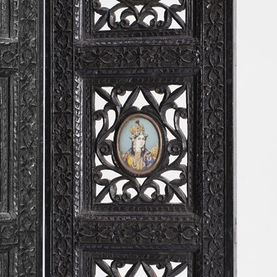 Lot 147 - An Anglo-Indian carved hardwood table screen