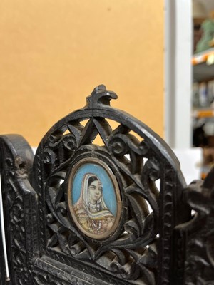 Lot 147 - An Anglo-Indian carved hardwood table screen