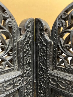 Lot 147 - An Anglo-Indian carved hardwood table screen