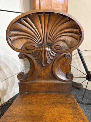 Lot 32 - A pair of Regency oak hall chairs