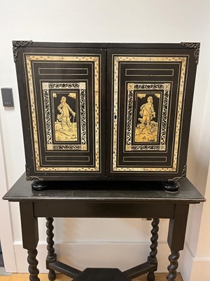 Lot 99 - An ebonised fruitwood, ivory-inlaid and bronze-mounted table cabinet