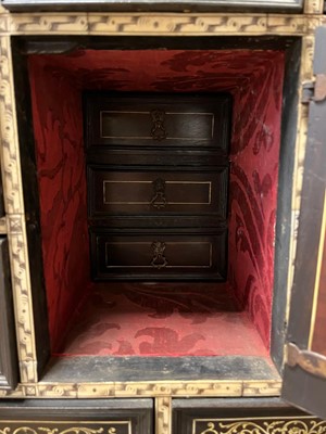 Lot 99 - An ebonised fruitwood, ivory-inlaid and bronze-mounted table cabinet