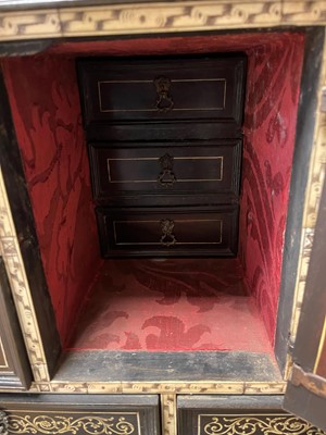 Lot 99 - An ebonised fruitwood, ivory-inlaid and bronze-mounted table cabinet