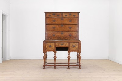 Lot 552 - A walnut chest on stand