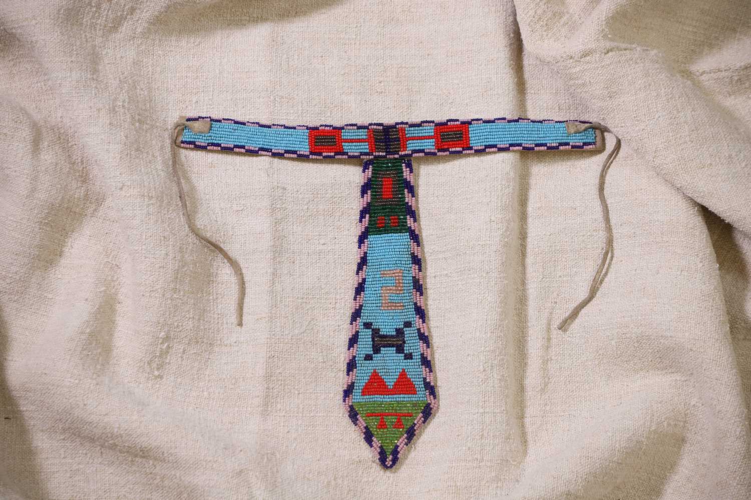 Lot 340 - A Native American beaded hide child's collared tie