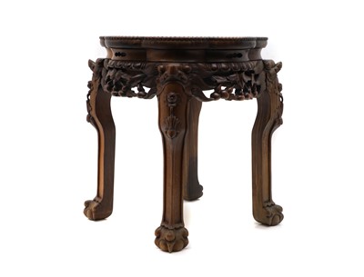 Lot 555 - A carved hardwood jardiniere stand