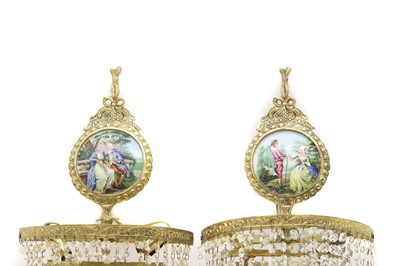 Lot 681 - A pair of porcelain and ormolu wall lights