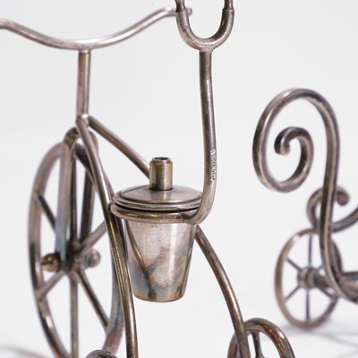Lot 99 - A silver-plated tricycle bottle stand