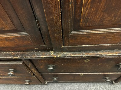 Lot 154 - A grained oak clock cupboard