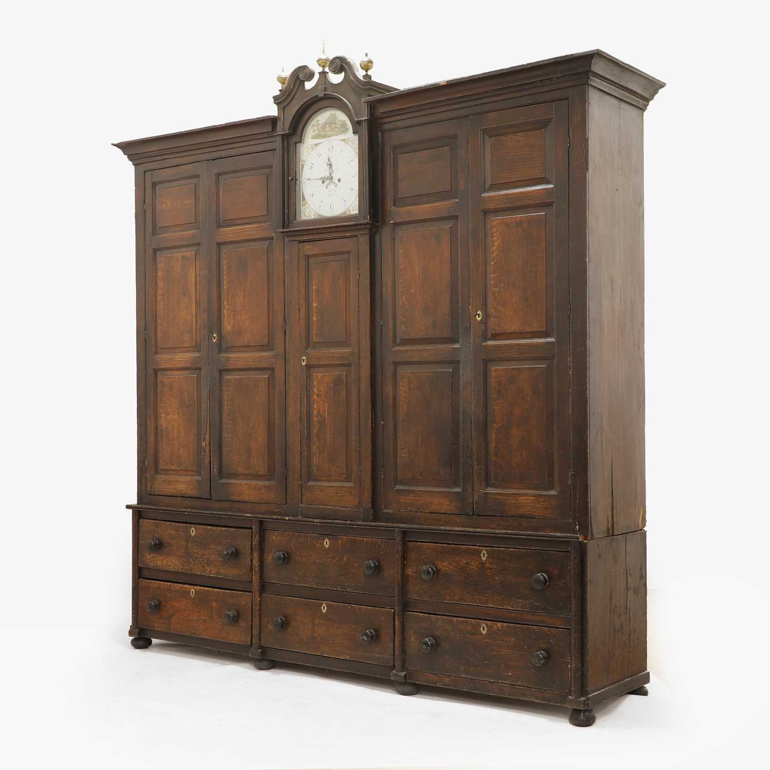 Lot 154 - A grained oak clock cupboard