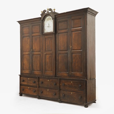 Lot A grained oak clock cupboard