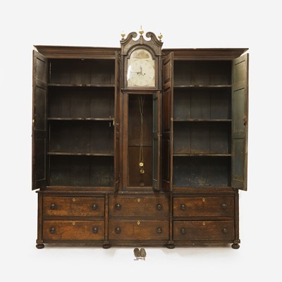 Lot 154 - A grained oak clock cupboard