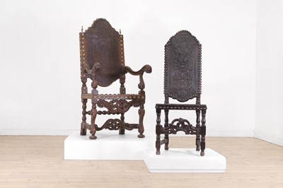 Lot 243 - A harlequin set of twelve carved walnut and studded-leather throne chairs