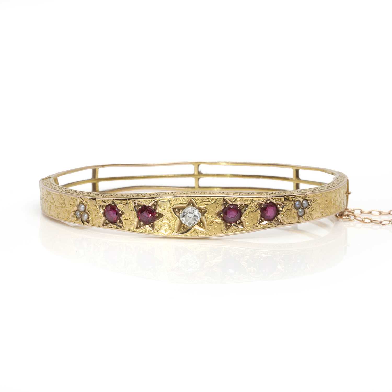 Lot 10 - A Victorian ruby, diamond and split pearl hinged bangle