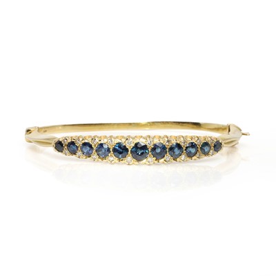 Lot 204 - An 18ct gold sapphire and diamond hinged bangle