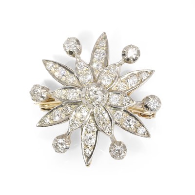 Lot 179 - A two colour gold diamond snowflake brooch/pendant