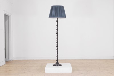 Lot 615 - An ebonised wooden floor lamp