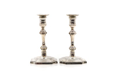 Lot 34 - A pair of George III style candlesticks