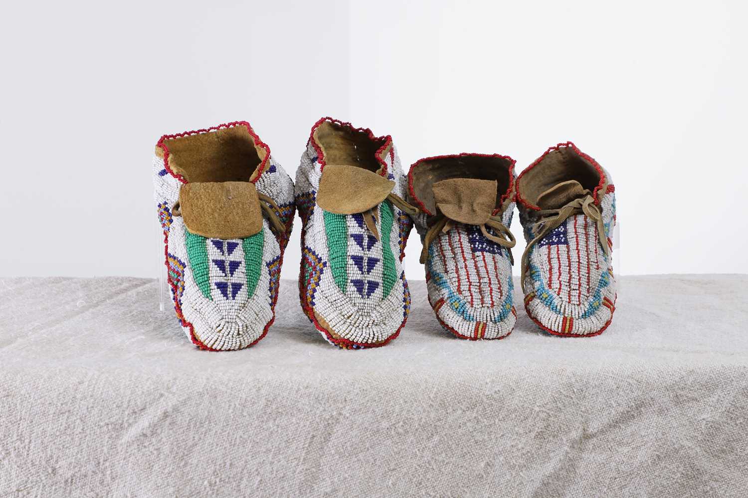 Lot 348 - Two pairs of Native American beaded hide moccasins