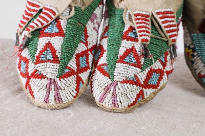 Lot 342 - A collection of Native American children's beaded hide moccasins