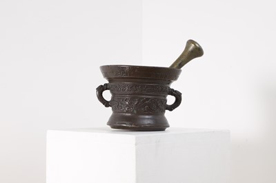 Lot 414 - A bronze mortar and associated pestle