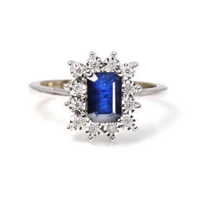 Lot 1160 - A white gold sapphire and diamond cluster ring